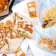 Array of Taco Bell foods and sauces on wrappers